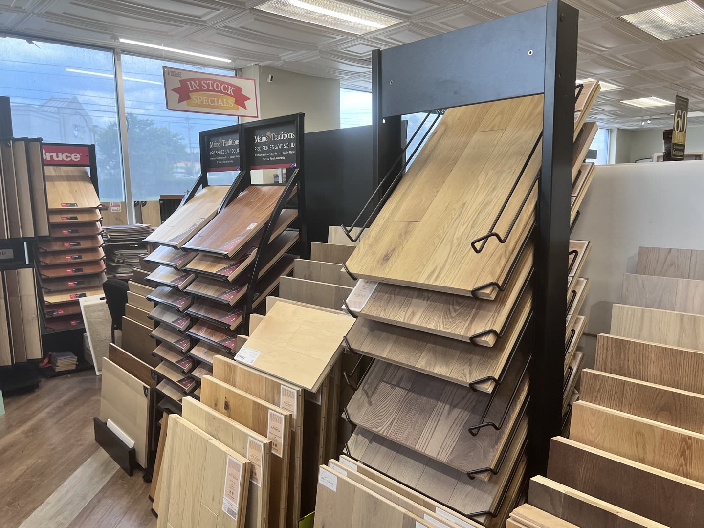 Hardwood plank samples stacked at the Royalty Carpet & Flooring showroom in Wappingers Falls