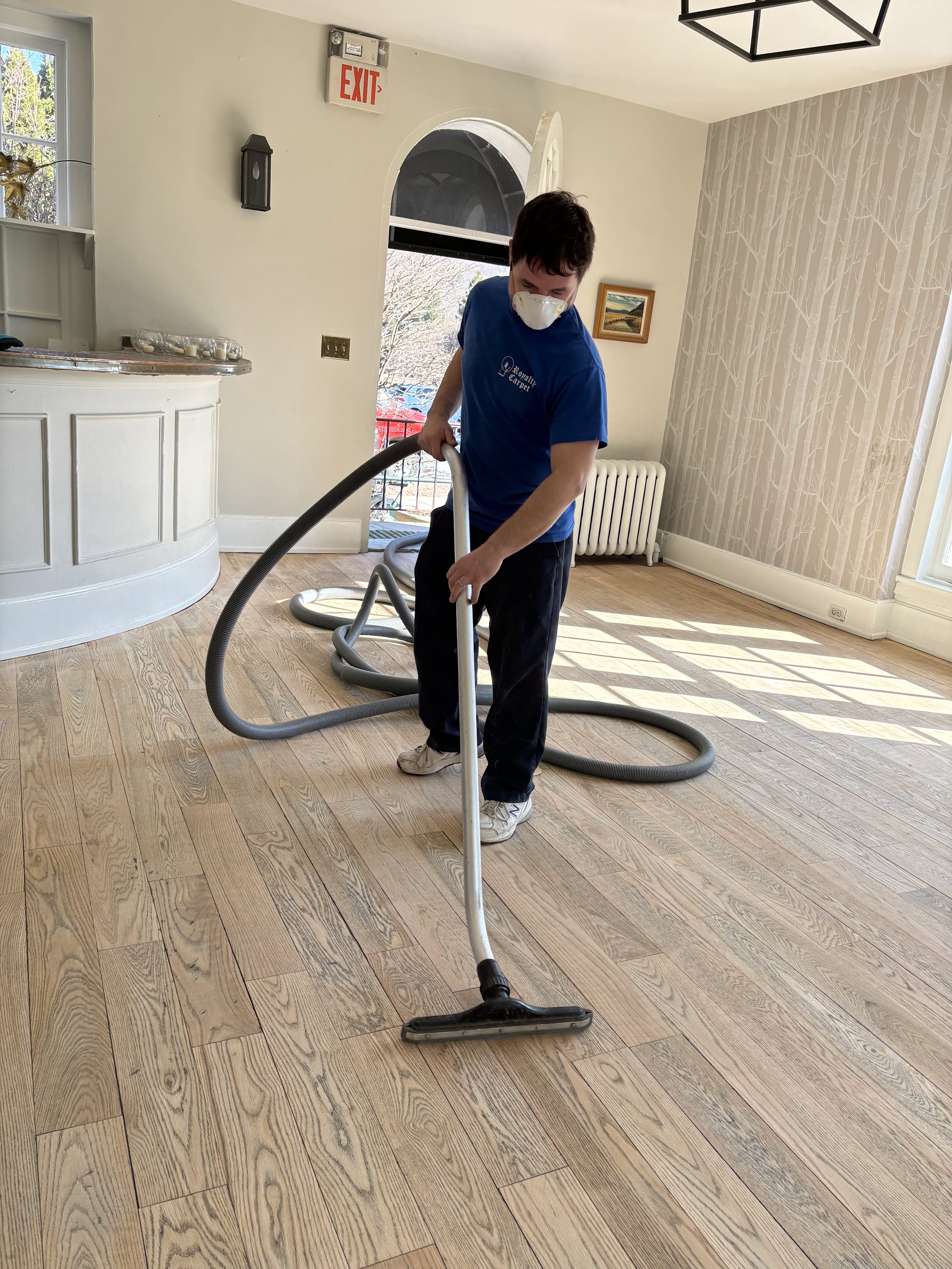 Royalty Carpet technician in a branded shirt deep-cleaning floors in a Hudson Valley home